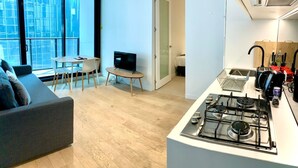 A modern apartment with a living room, dining area, and kitchen. - Charming Dual-Unit Retreat on Elizabeth St (Melbourne)