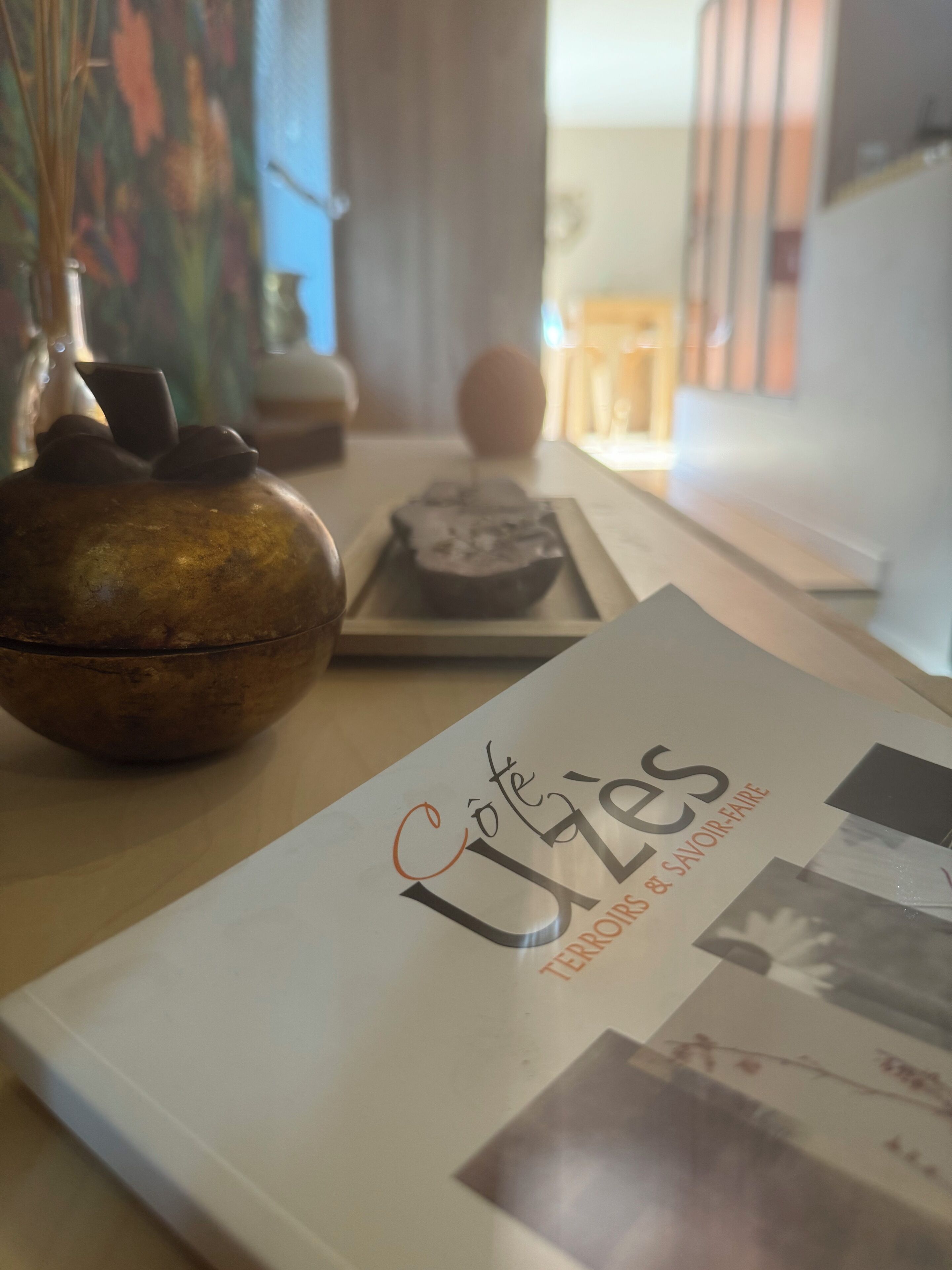 A table with a book titled 'Café Utés' and a decorative bowl.