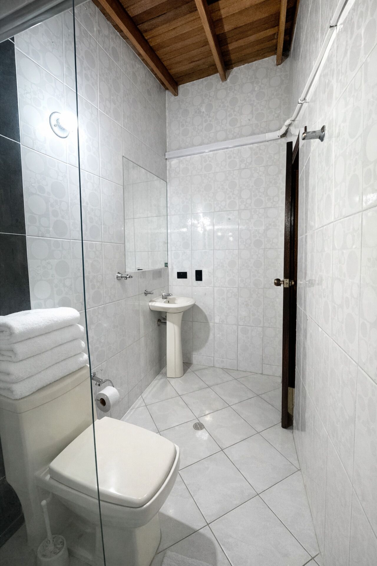 Een badkamer met toilet, wastafel en douche.