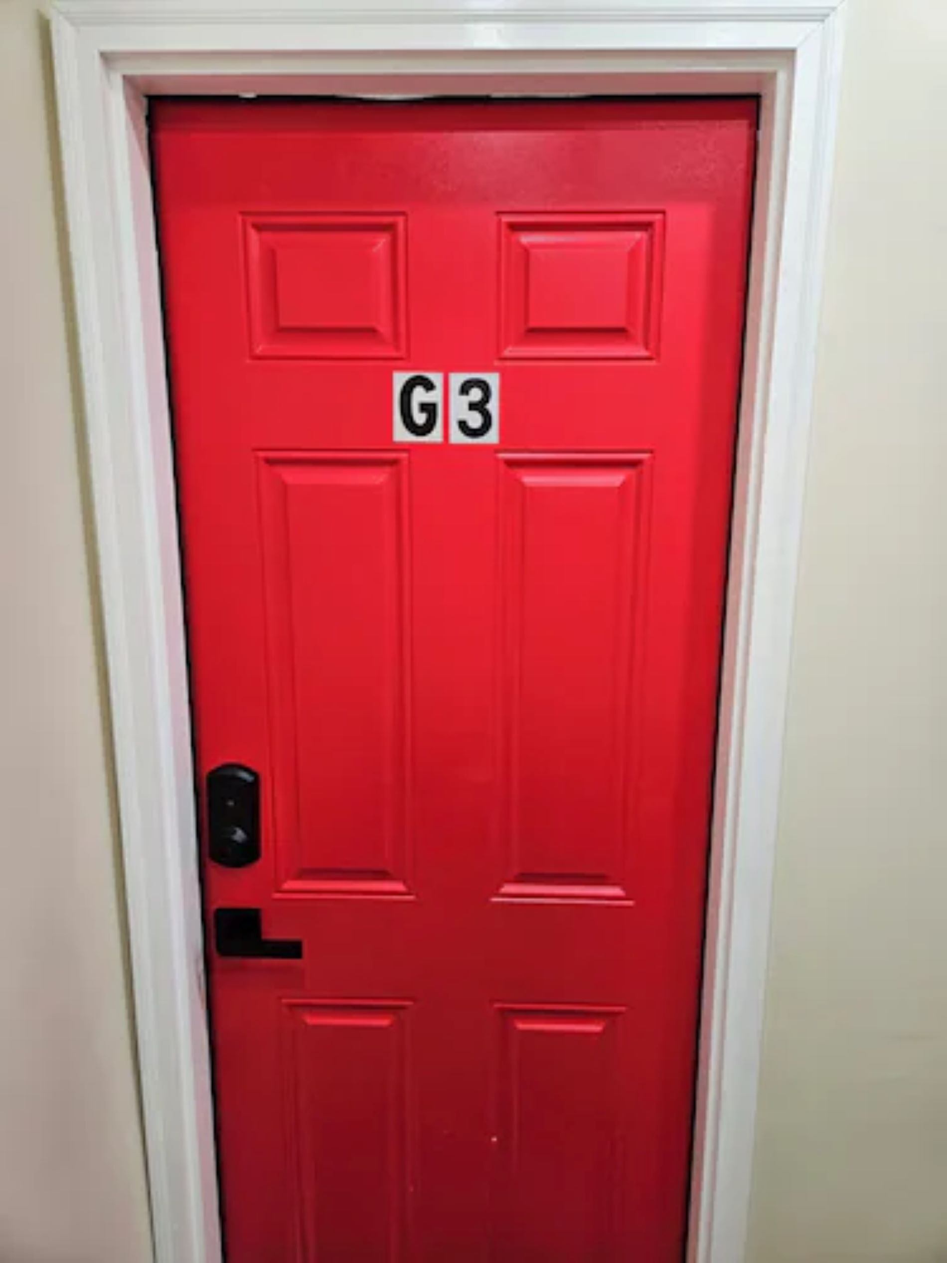 A red door with a G3 sign above it.