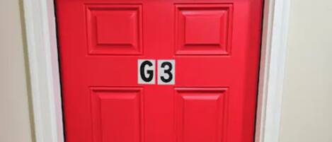 A red door with a G3 sign above it.