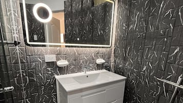 Shower, hair dryer, towels, toilet paper