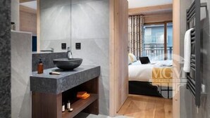 Un bagno moderno con uno specchio grande, un lavabo a incasso e un mobile contenitore in legno.