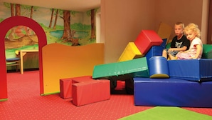 A play area with colorful play structures and a mural of a forest scene. - Holiday apartment with wellness area (Ötz im Ötztal)