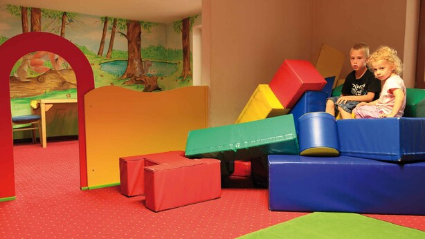 A play area with colorful play structures and a mural of a forest scene. - Holiday apartment with wellness area (Ötz im Ötztal)