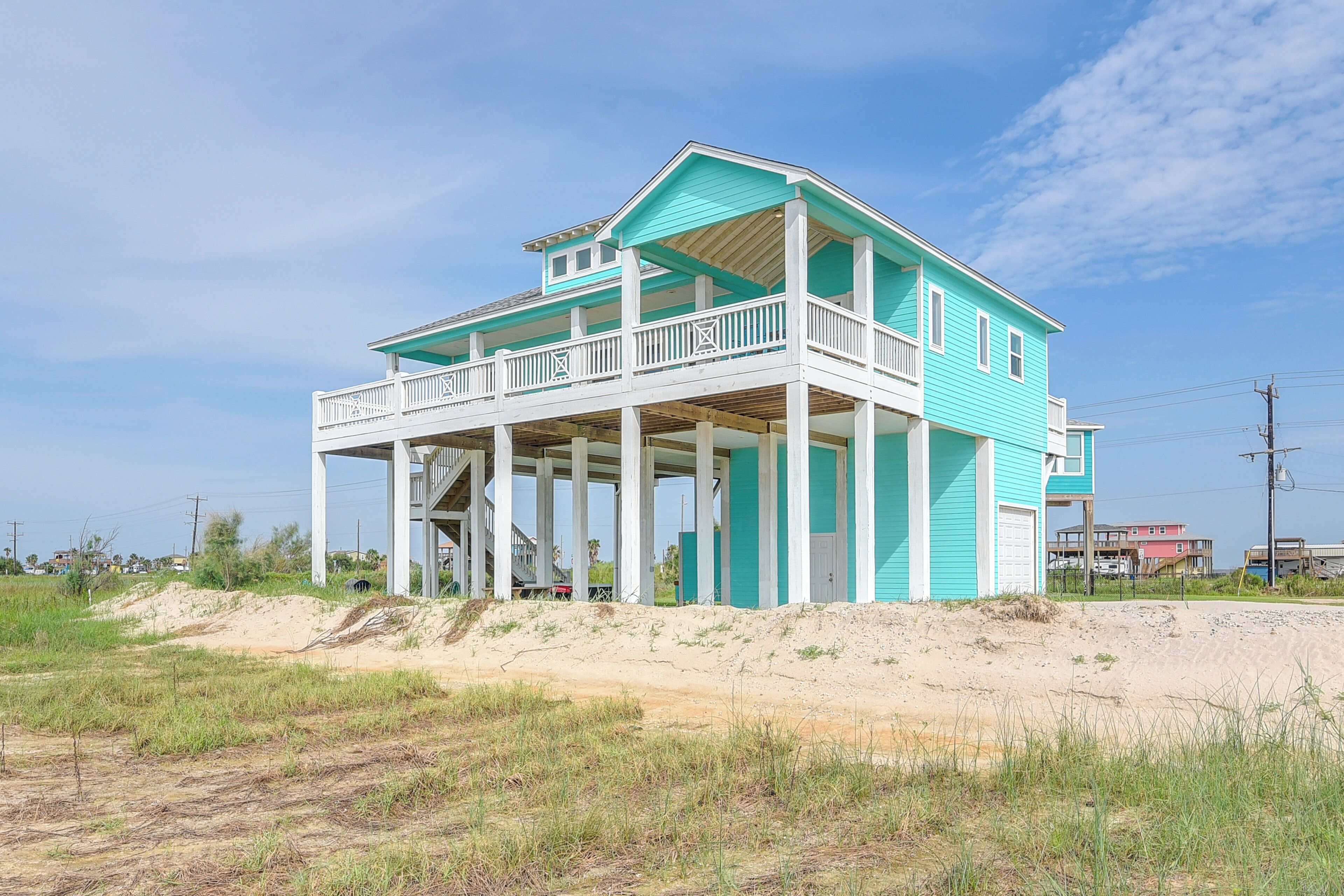 A two-story house with a balcony and a covered porch.