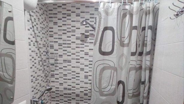 A bathroom with a shower, a sink, and a toilet. - Domus Felix  (Ercolano)