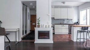 A modern kitchen with white cabinets, a built-in oven, and a bar area. - Beautiful 1BR Apartment in Lahti Center (Lahti)