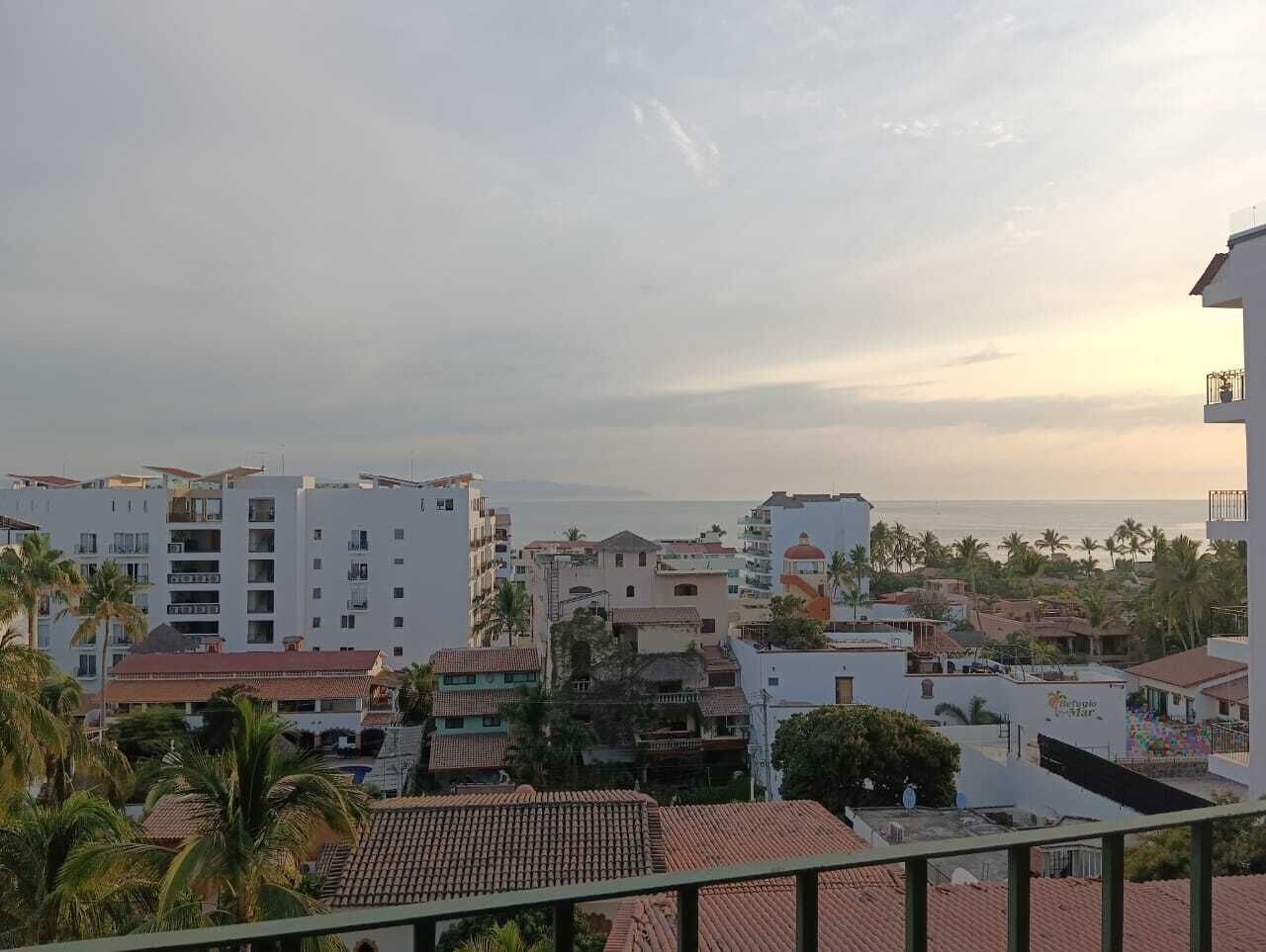 A coastal cityscape with a variety of buildings, including residential and possibly commercial structures.