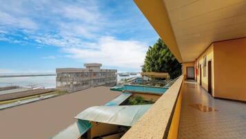A hotel corridor with a view of the beach and ocean.