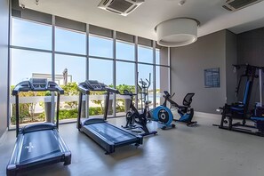A gym with treadmills, elliptical machines, and a stationary bike.