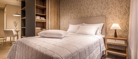 A neatly made bed with a headboard, a bedside table with a lamp, and a wardrobe with shelves.