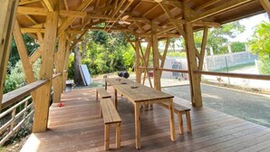 A wooden pavilion with a sloped roof, picnic tables, and benches. - Ecolodge Barbuda - Natural Pool & Beach (Saint-François)