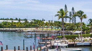 A marina with docked boats, a private pool, and a beach house. - 5 Beautiful 4 Bed 3 Bath Pool Home w Free Dock (Marathon)