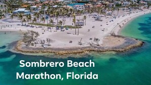 A beach with clear turquoise waters and a sandy shore. - 5 Beautiful 4 Bed 3 Bath Pool Home w Free Dock (Marathon)