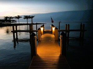 A wooden pier leading to a dock with a view of the water and palm trees in the background. - 1 Beautiful 4 Bed 3 Bath Pool Home w Free Dock (Marathon)