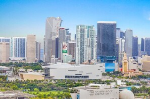 A cityscape with modern high-rise buildings, a large white building with a dome, and a park area with trees. - City Vibes Ocean View Next to Art Basel (Miami)