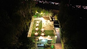 An aerial view of a hotel with a rooftop garden, outdoor seating area, and a swimming pool. - Purple Tree Villa Delhi  (New Delhi)