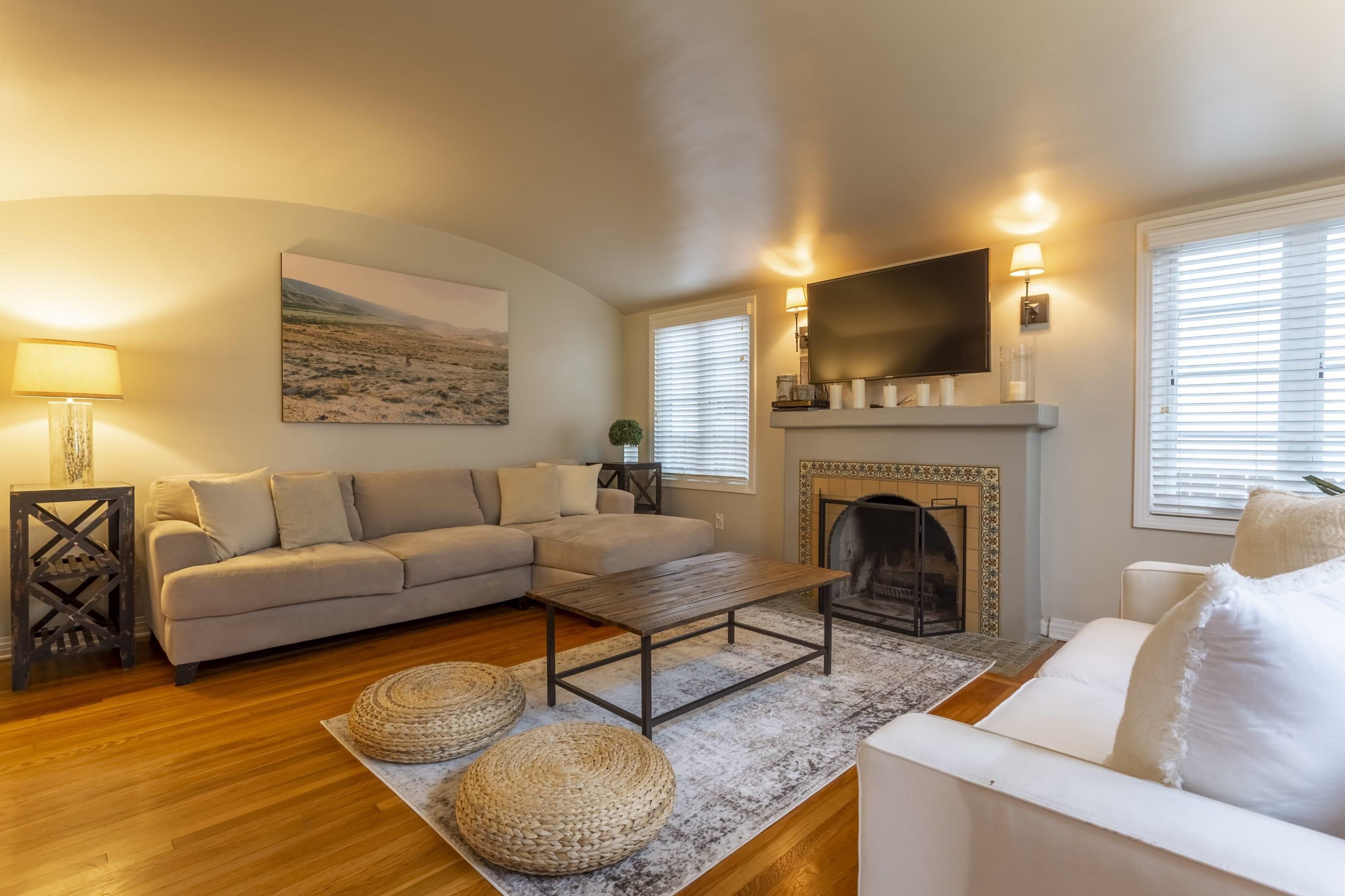A living room with a sofa, coffee table, and fireplace.