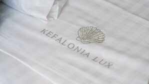 A white fabric with embossed text "KEFALONIA LUX" and a shell design.