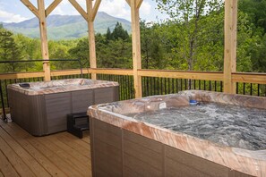A wooden deck with two hot tubs and a view of mountains. - Breathtaking 14br Cabin Elevator Views Games Hot Tubs Galore (Sevierville)