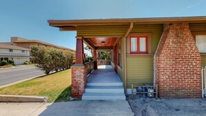 A single-story building with a covered porch, a brick chimney, and a small garden area. - Cozy Alhambra 3BR Near Downtown Los Angeles (Alhambra)