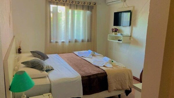 Relax in this serene bedroom with a comfortable bed, flat-screen TV, and a cozy reading nook.
