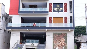 A multi-story building with a prominent sign reading "GOKULAM GRAND".