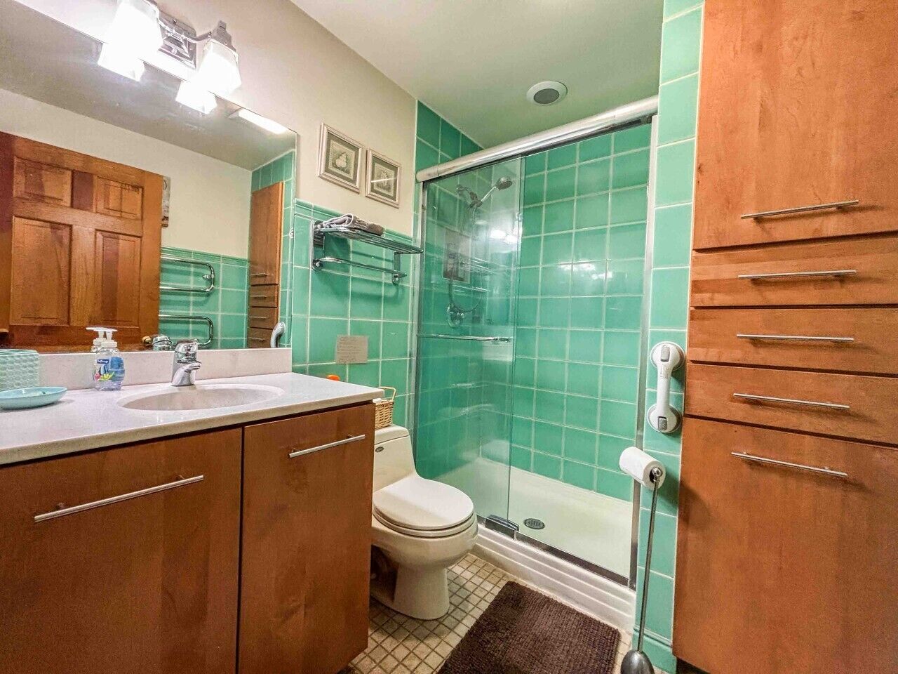 A bathroom with a shower, toilet, and sink.