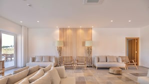 A modern living room with a sofa set, two armchairs, a coffee table, and a wooden accent piece. - Resort Rural Quinta do Carrascal (Rio Maior)