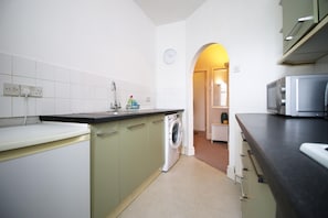 Fridge, microwave, toaster, dining tables