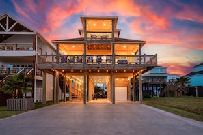 A multi-story building with a covered entrance and outdoor seating area.