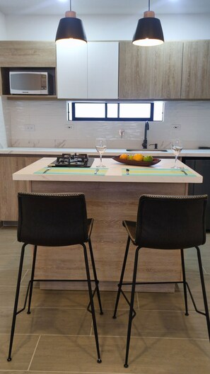 Fridge, microwave, coffee/tea maker, cookware/dishes/utensils