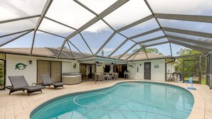 An indoor swimming pool with a glass ceiling, lounge chairs, and a hot tub. - Pool - 3 bedrooms - 2 baths - Pet Friendly - 3 Miles to Beach (Bonita Springs)