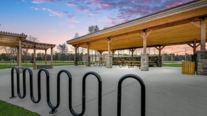 A covered picnic area with benches and a stone pillar structure. - Modern 3br/2ba with 3 king beds · Pool · Pets OK! (Patton Village)