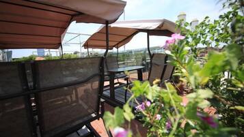 Outdoor seating with umbrellas, a table, and chairs.