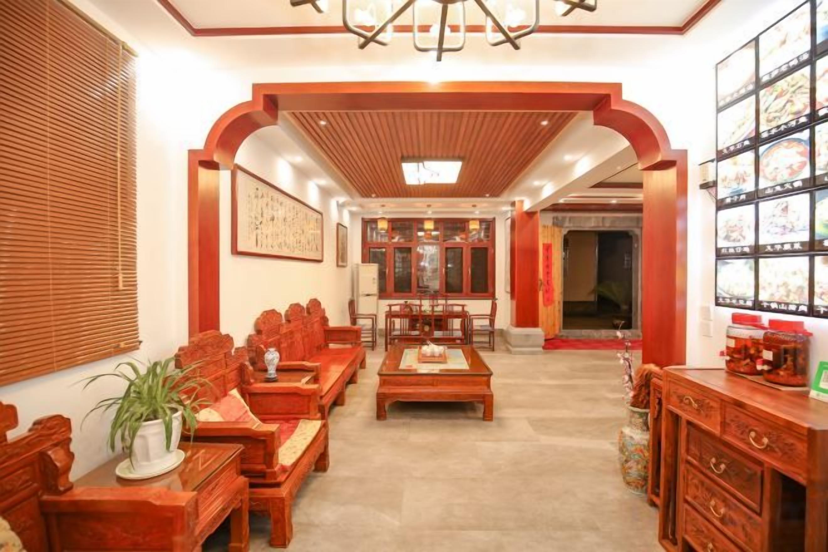 A traditional interior with wooden furniture, a central table, and a bookshelf.