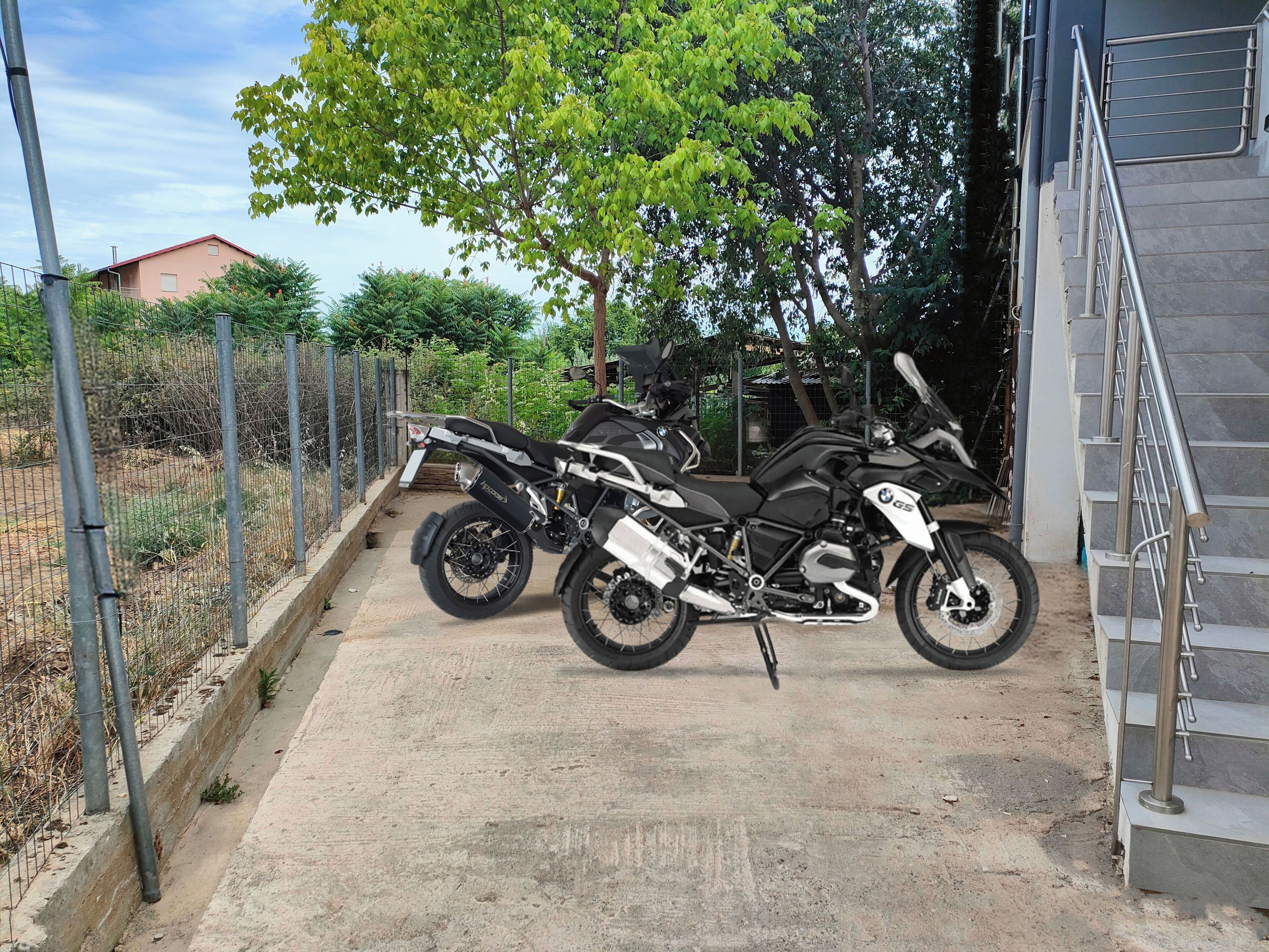 Two motorcycles parked near a staircase.