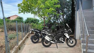 Two motorcycles parked near a staircase.