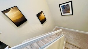 A staircase with a white railing and beige carpet. -  Luxury home in Newport Beach city Near UCI (Newport Beach)