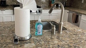 A kitchen with granite countertops, a stainless steel sink, a paper towel dispenser, a soap dispenser, and a digital scale. -  Luxury home in Newport Beach city Near UCI (Newport Beach)