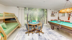 A room with a pool table, a green sofa, and a bunk bed. - ‘Rhodes Retreat’ w/ Dock on Cedar Creek Lake! (Log Cabin)