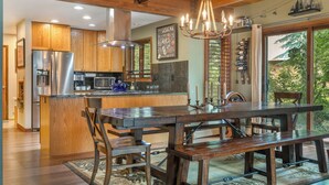 A modern kitchen with wooden cabinets, stainless steel appliances, and a large island with seating. - Private Hot Tub & Pet Friendly + Beds For Any Group Dynamic (Avon)