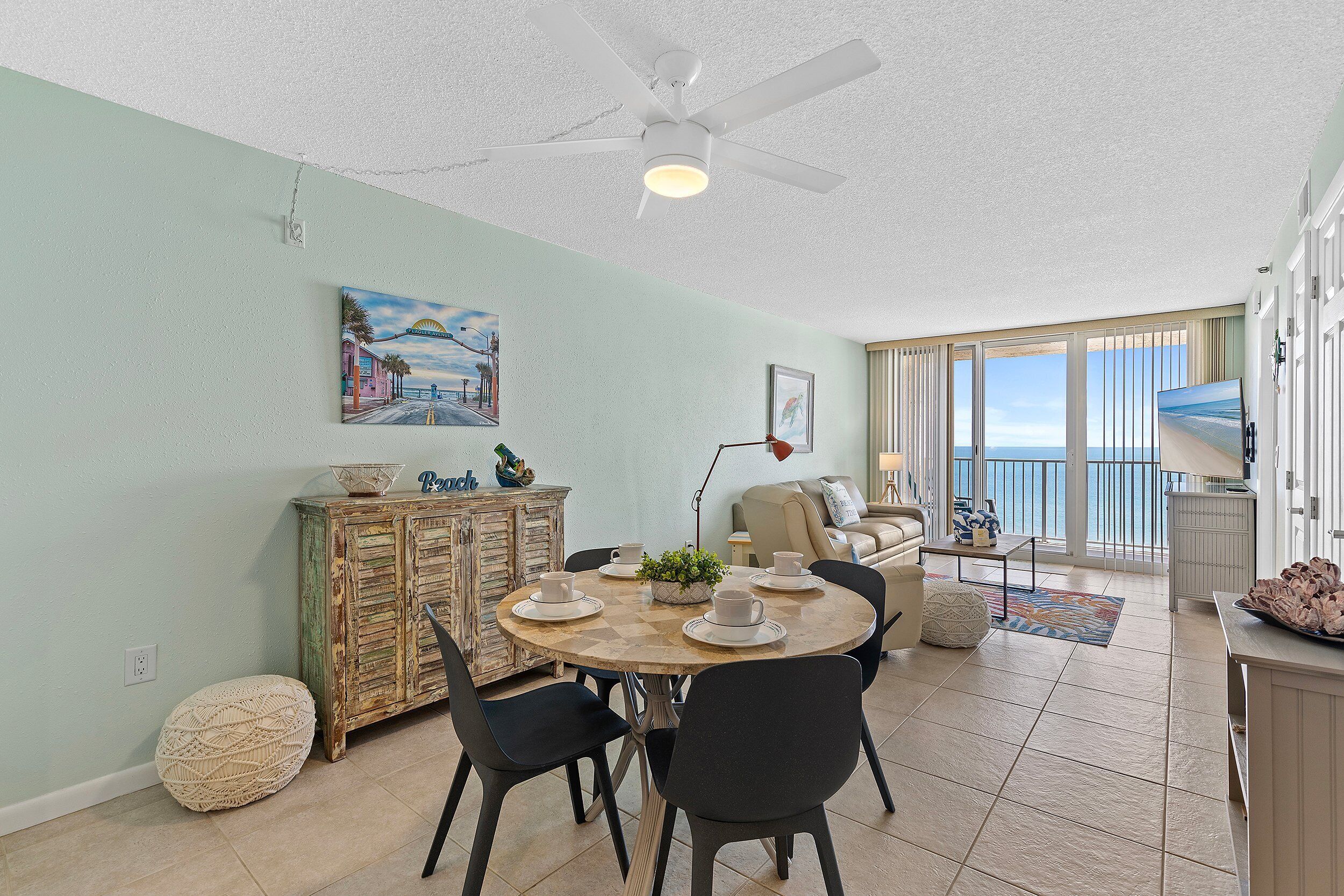 A dining area with a round table, chairs, and a vintage cabinet.