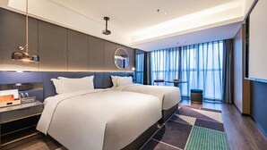 A modern hotel room with two beds, a large window with curtains, a round mirror, and a small table with a chair. - Mei Hao Li Jinhui Square sto (Xi'an)