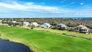 A golf course with houses in the background.