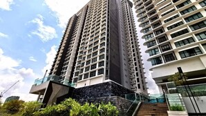 A high-rise building with multiple floors, large windows, and a modern architectural design. - City View Southkey 2BR2FREE 18F By Natol (Johor Bahru)