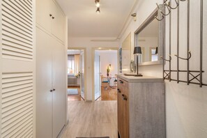 A hallway with a wardrobe, a mirror, and a radiator.