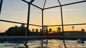 A large, open, geometric structure with a clear view of the sky and a body of water in the foreground. - The Blooming Sanctuary - 3br with pool and EV-Charger (Rotonda West)