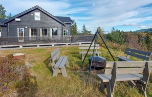 A rustic wooden house with a sloped roof and a porch. - 4 bedroom cozy home in Skollenborg (Skollenborg)